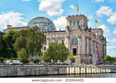 BERLIN, GERMANY - AUGUST 07, 2017: The Reichstag in Berlin on the banks of the river Spree. The Reichstag is one of the most important sights of the city