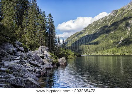 Morskie Oko lake with rocks under water at Tatra Mountains, Poland.