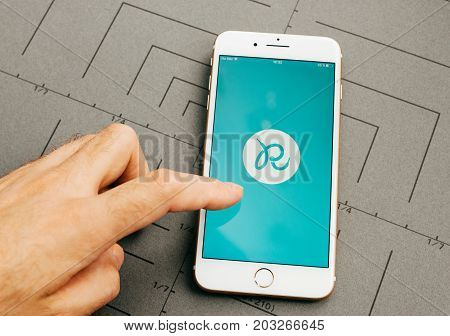 PARIS FRANCE - SEP 26 2016: Male hand holding New Apple iPhone 7 Plus after unboxing and testing by installing the app application software Runtastick sport tracking app for runners