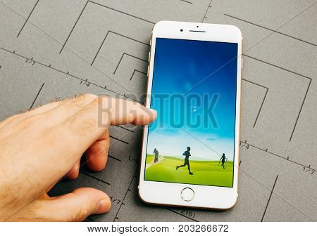 PARIS FRANCE - SEP 26 2016: Male hand holding New Apple iPhone 7 Plus after unboxing and testing by installing the app application software Runtastick sport tracking app for runners