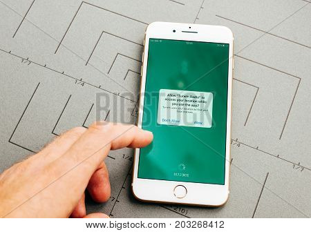 PARIS FRANCE - SEP 26 2016: Male hand holding New Apple iPhone 7 Plus after unboxing and testing by installing the app application software tunein radio