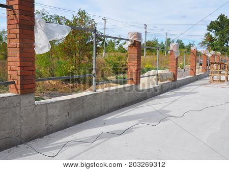 Building a Metal and Concrete Bricks Fence with Iron Bar Framework