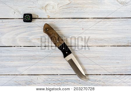 Knife On A White Wooden Background.