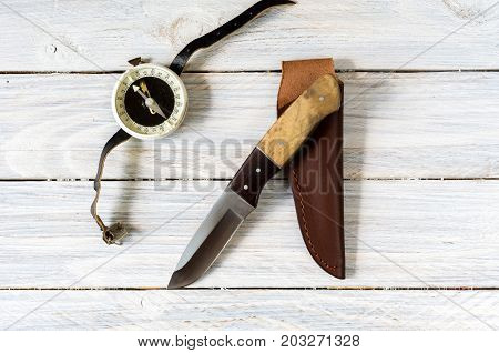 Outdoor Composition With A Knife And Compass On A White Background.