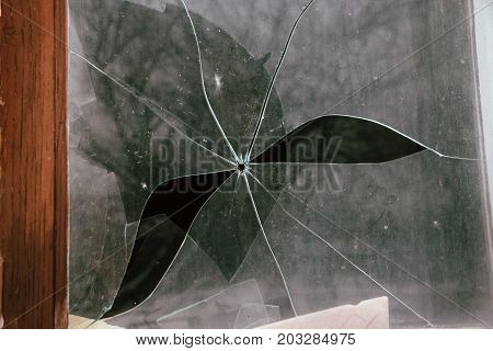 Broken glass with the hole from the bullet