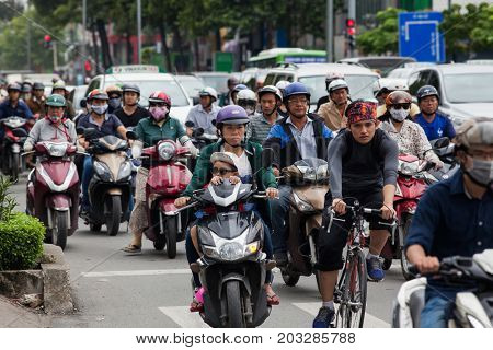 HO CHI MINH CITY (SAIGON), VIETNAM - JULY 2017 : Road traffic in Saigon, Vietnam. In the biggest city in Southern Vietnam are more than 4 mil. motorbikes, the traffic is often congested