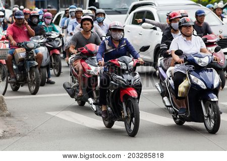 HO CHI MINH CITY (SAIGON), VIETNAM - JULY 2017 : Road traffic in Saigon, Vietnam. In the biggest city in Southern Vietnam are more than 4 mil. motorbikes, the traffic is often congested