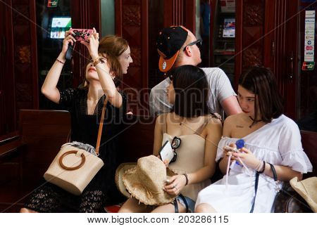 HO CHI MINH CITY (SAIGON), VIETNAM - JULY 2017 : tourists inside the central post office in neoclassical architectural style, designed and constructed by the famous architect Gustave Eiffel.