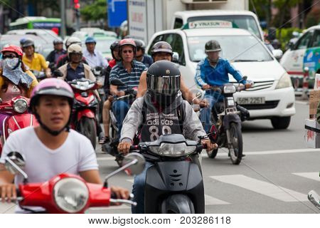 HO CHI MINH CITY (SAIGON), VIETNAM - JULY 2017 : Road traffic in Saigon, Vietnam. In the biggest city in Southern Vietnam are more than 4 mil. motorbikes, the traffic is often congested