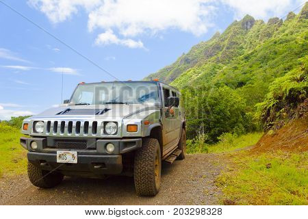 Hawaii - June 2012: A tourist guid drives his hummer to explore the magneficient landscape with them.
