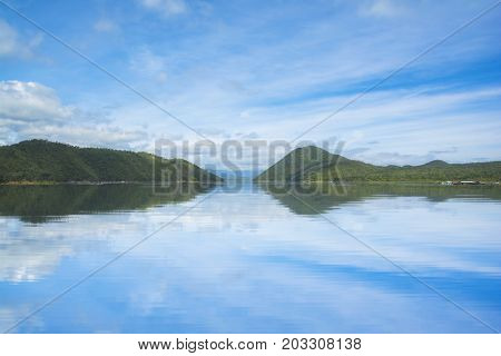 Beautiful sky and mountain with water reflection from Srinakarin Kanchanaburi Thailand. Nature background.
