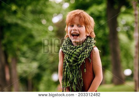 Red head boy playing in the park
