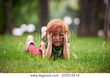 Red head boy playing in the park
