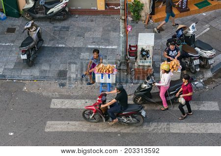 Hanoi Vietnam - August 12 2017: Street food vendors selling bread rolls on sidestreet in Hanoi. View from above