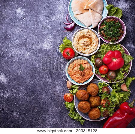 Selection of Middle eastern or Arabic dishes. Falafel, hummus, pita and  muhammara. Top view