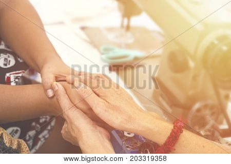 Two women praying together and encourage each other. color filter added.