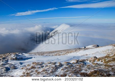 Mountain peak above the clouds. Sunny winter day on mountain above the clouds. Dry mountain in Serbia in winter with highest peak Trem