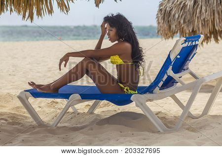sexy black girl is relaxing on the beach