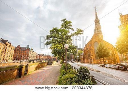 Beautiful cityscape view on the old downtown with saint Catherines church during the sunset in Hamburg city, Germany