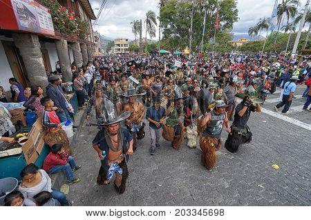 June 29 2017 Cotacachi Ecuador: indigenous Kichwa crowd dancing on the street celebrating Inti Raymi