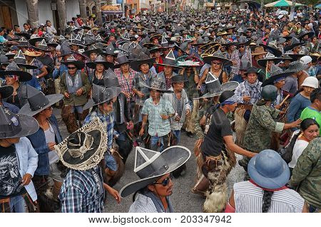 June 29 2017 Cotacachi Ecuador: indigenous Kichwa crowd on the street celebrating Inti Raymi