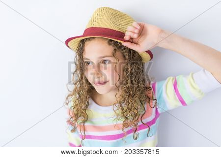 A Portrait of 9 years old girl with curly hair, isolated on gray