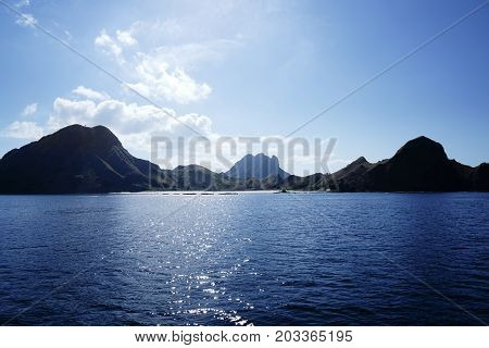Coastline Of Mountains And A Small White Sand Beach In Blue Ocean Water At Labuan Bajo In Flores, In