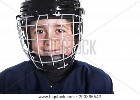 A Young boy in ice hockey gear against white