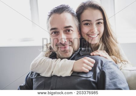 A nice and cool Teenager girl sitting on window with father
