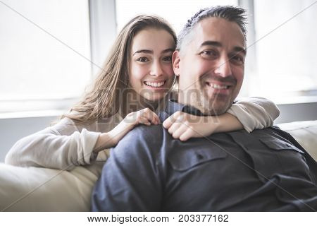 A nice and cool Teenager girl sitting on window with father
