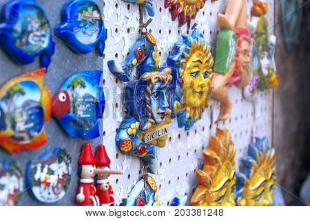 Souvenirs of the Trinacria symbol of Sicily and typical Sicilian glazed ceramic