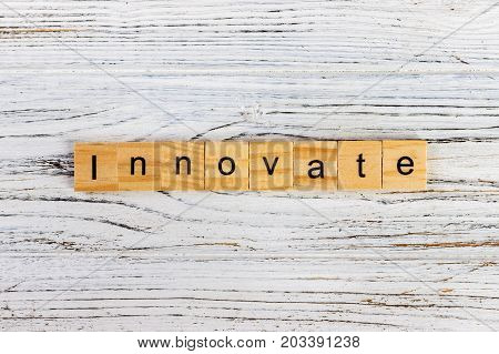 INNOVATE word made with wooden blocks on the table