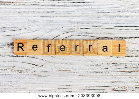 REFERRAL word made with wooden blocks concept