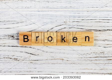 BROKEN word made with wooden blocks concept