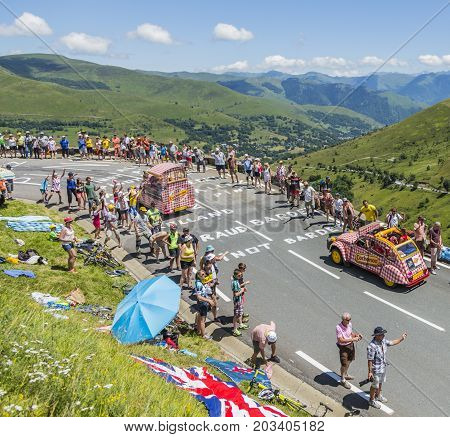 Col de PeyresourdeFrance- July 23 2014: Cochonou vehicle passing in the Publicity Caravn on the road to Col de Peyresourde in Pyrenees Mountains during the stage 17 of Le Tour de France 2014.