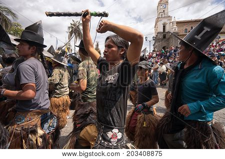 July 24 2017 Cotacachi Ecuador: indigenous kichwa men dancing on the street at Inti Raymi celebration