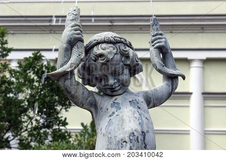 statue fountain, boy with ryba in hands