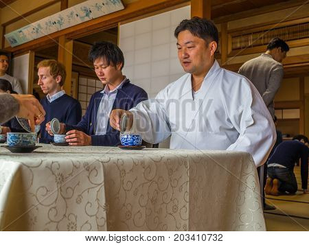 KYOTO, JAPAN - JULY 05, 2017: Unidentified people at table in a meeting reunion, drinking tea, in Kyoto, Japan
