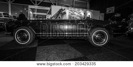 MAASTRICHT NETHERLANDS - JANUARY 08 2015: Car Mercedes-Benz 280SL (W113). Black and white. International Exhibition InterClassics & Topmobiel 2015