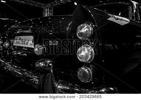 MAASTRICHT NETHERLANDS - JANUARY 08 2015: The rear brake lights of a full-size luxury car Bentley S3 Continental. Black and white. International Exhibition InterClassics & Topmobiel 2015