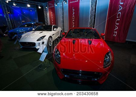 MAASTRICHT NETHERLANDS - JANUARY 08 2015: Sports cars Jaguar F-Type Roadster (foreground) Coupe and XF Sportbrake (background). International Exhibition InterClassics & Topmobiel 2015