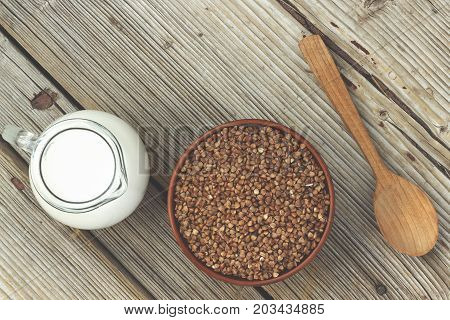 Baby food or sports nutrition. Buckwheat and milk wooden floor