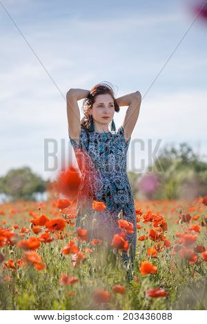 Portrait Of Pensive Woman On Poppy Field