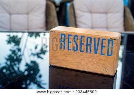 Big table at retaurant served for upcoming banquet with reserved sign