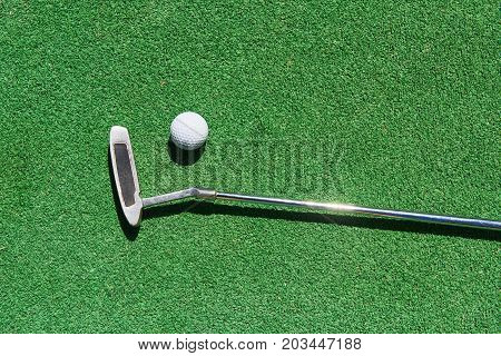 Mini-golf ball on artificial grass. Summer season game
