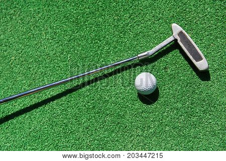 Mini-golf ball on artificial grass. Summer season game