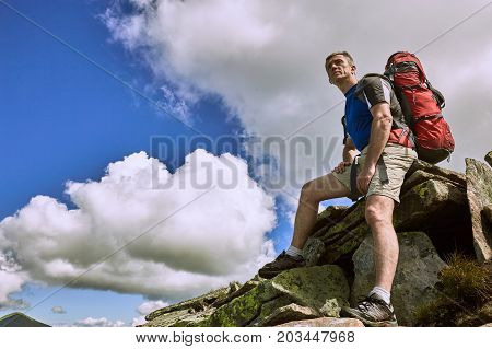 Hiking in the mountains with a backpack in the summer.