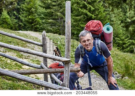 Hiking in the mountains with a backpack in the summer.