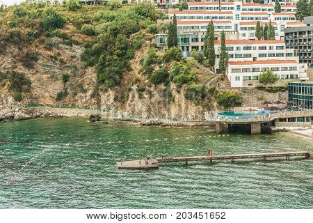 Budva, Montenegro - August 20, 2017: View of the modern beach town of Budva, Montenegro. Budva is one of the best and most popular resorts of the Adriatic Riviera. Beautiful beach at Budva's riviera.