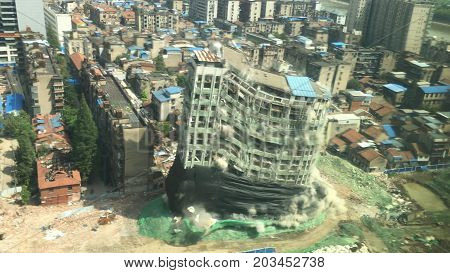 Downtown building demolition by controlled implosion in China